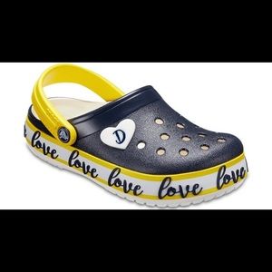 ISO women’s “Love” crocs, size 8.